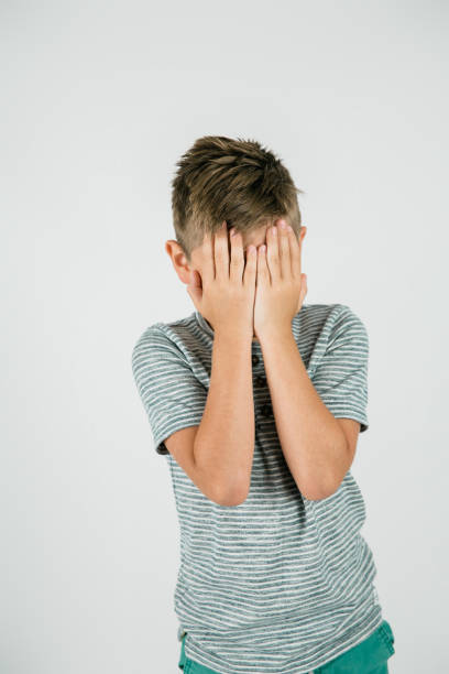 istock Little boy with his hands covering his eyes 1302446418