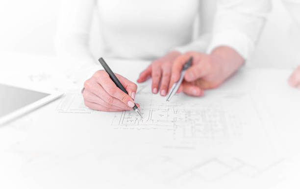 istock Engineers in the office are conferring on project drawings. 1302447074