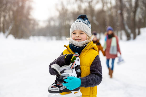 istock Little boy going ice skating with his family 1302447537
