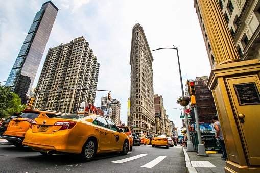 New York, USA - August 7, 2018: a New York traffic scene with lots of taxis and cars, under the Flatiron Building