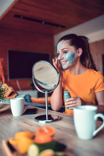 istock Smiling Female Beauty Using Special Facial Mask To Clean Skin 1302448708