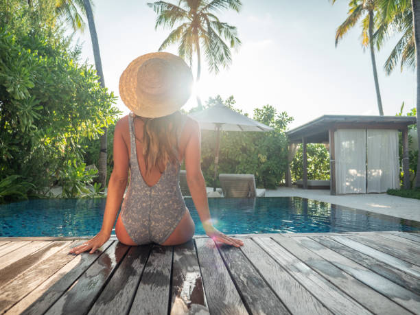 woman enjoying luxury vacations from private pool villa - swimming pool resort swimming pool poolside sea imagens e fotografias de stock