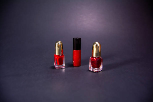 istock Red lipstick and nail polish on a black background. 1302449651