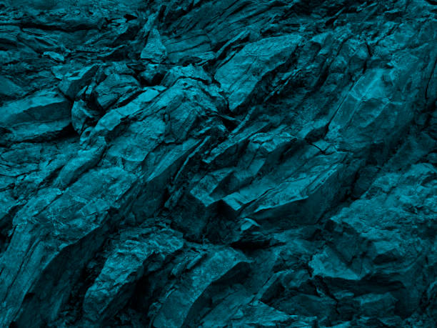 istock Blue green rock background. Dark turquoise toned mountain surface. 1302450436