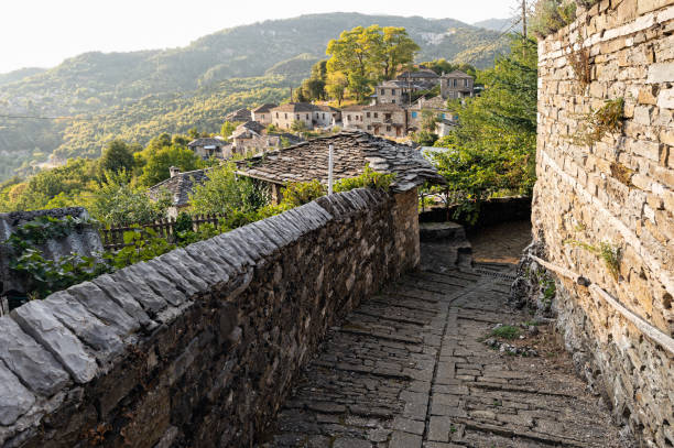 Traditional village in Greece Stone houses of traditional architecture and cobble-stone narrow street in Mikro Papigo in Epirus, Greece zagori stock pictures, royalty-free photos & images