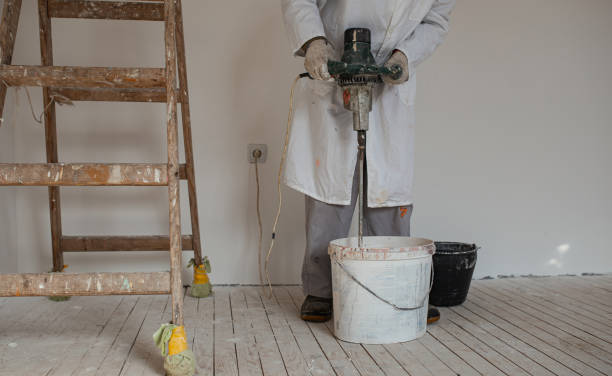 istock Preparing paint for wall painting with electric mixer 1302450944