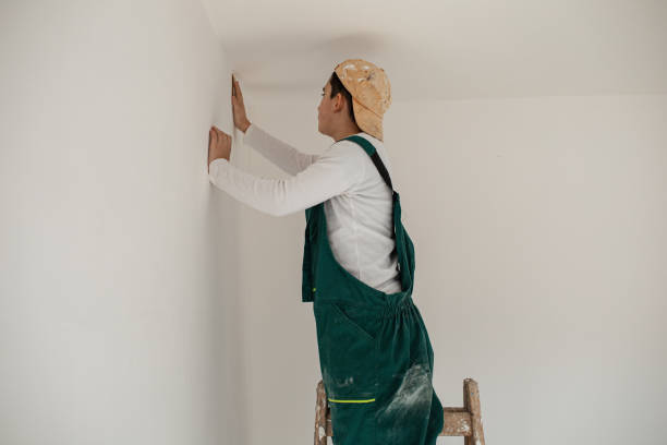 istock Senior manual worker preparing walls for painting 1302450948