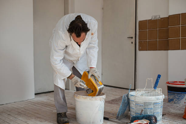 Manual worker trying to dilute vibrant yellow color