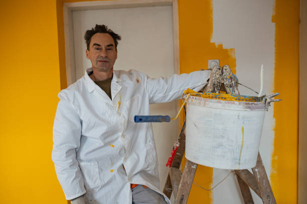 istock Senior manual worker ready with his tools for painting walls 1302451137