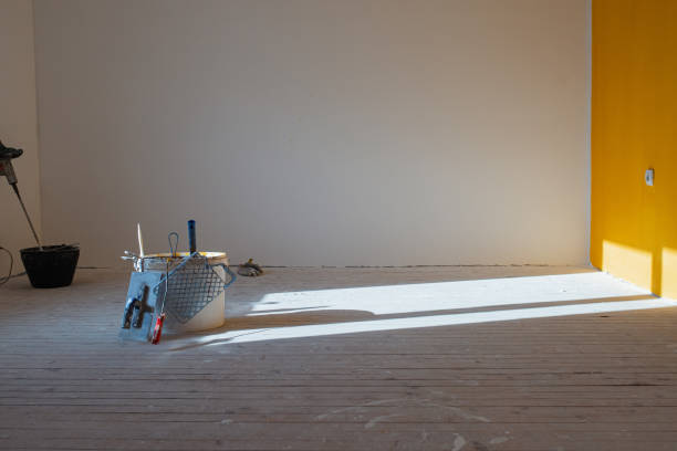 istock Work tools for painting walls placed on the floor of empty room 1302451700