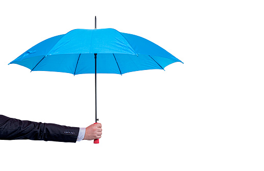 Umbrella in the hand of a businessman isolated on white background.
