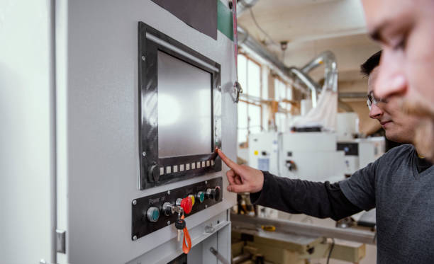 istock Portrait of carpentry workers with CNC machine 1302453608