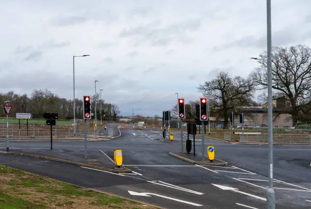 Newly built A14 renovation, a part of the largest road building project in Europe. It is nearing its completion is partially open with cars on it.  This is an incomplete junction heading into Huntingdon.