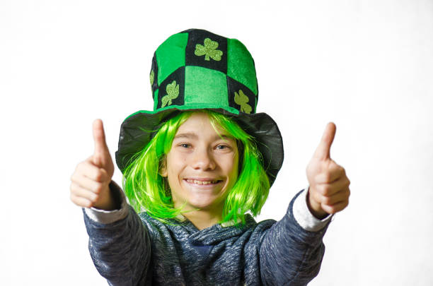 istock Young boy wearing green wig and hat for St. Patrick's day 1302454566