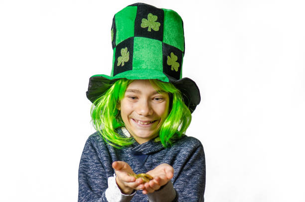 istock Young boy wearing green wig and hat for St. Patrick's day 1302454588