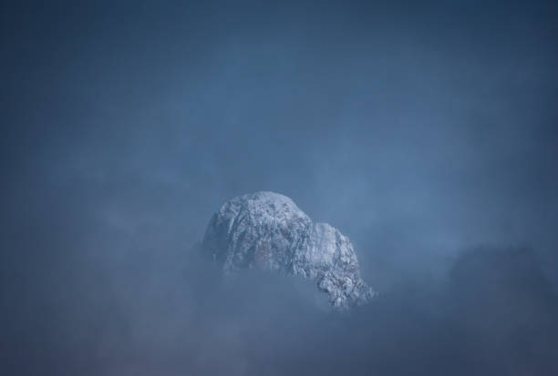 latemar gamme émergeant des nuages un jour d’hiver, trentin; italie - latemar mountain range photos et images de collection