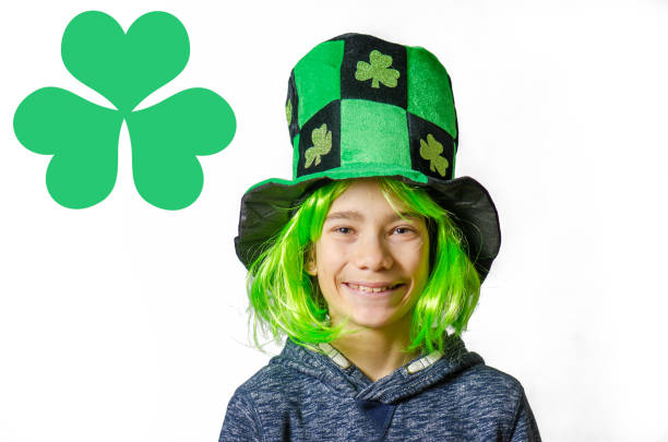 istock Young boy wearing green wig and hat for St. Patrick's day 1302454671