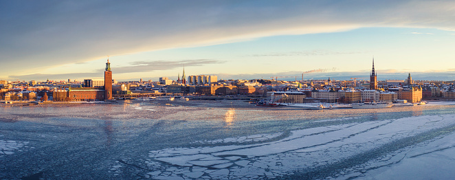 View of central Stockholm on a winter morning with the iconic city hall on the left and Riddarholmen and Gamla Stan on the right.