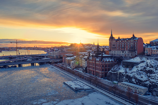 View of the sun rising on a winter morning by Slussen and Söder Mälarstrand in Södermalm in central Stockholm.