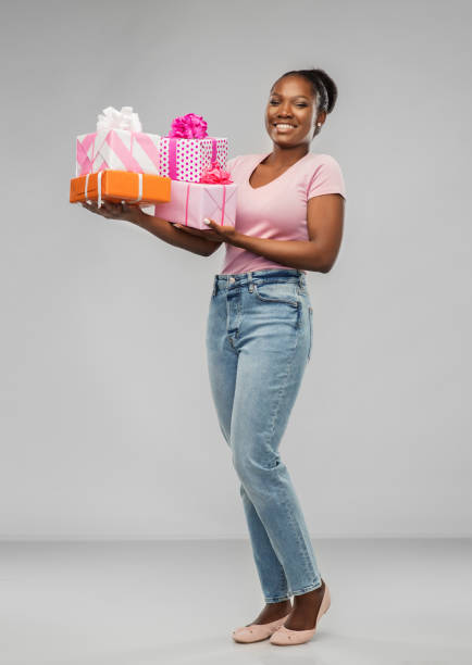 istock happy african american woman with gift boxes 1302455656