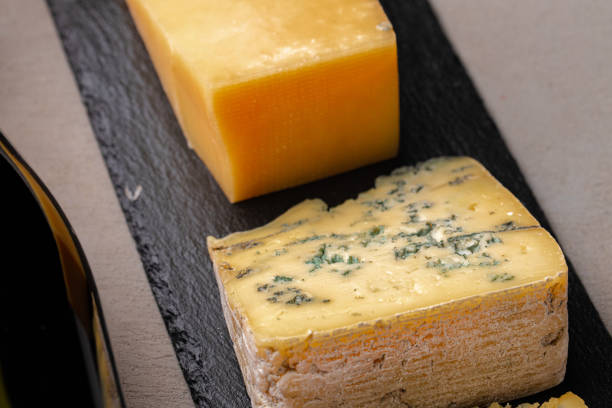 istock Several different pieces of cheese served on black stone flat plate 1302455877