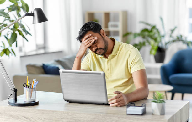 istock indian man with laptop working at home office 1302457338