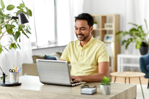 istock indian man with laptop working at home office 1302457352