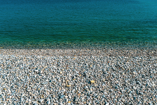 Textura of water and stones on the beach.