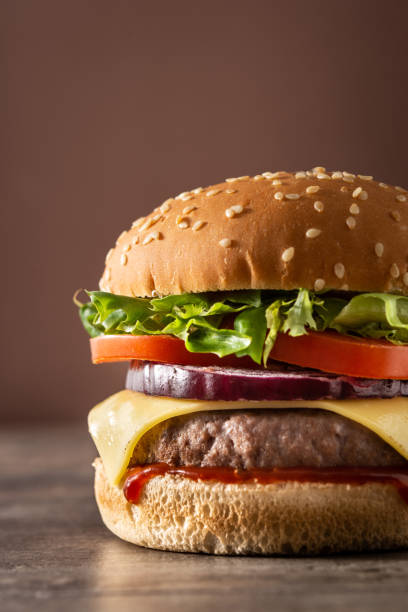 istock Cheeseburger with beef,tomato, lettuce and onion 1302460417