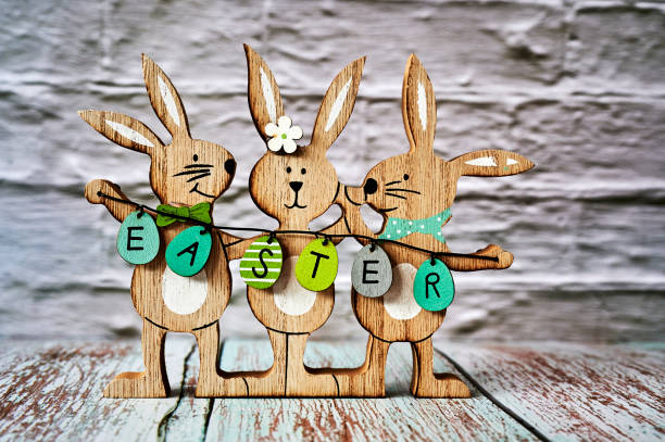 istock Three wooden Easter bunnies with decoration. 1302461605