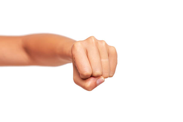 Close-up of a man's arm flexing with clenched fist against a plain white background