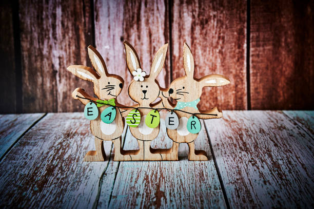istock Three wooden Easter bunnies with decoration. 1302462496