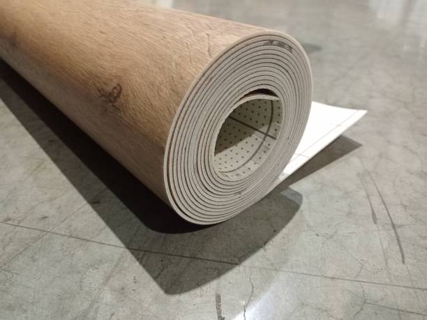 istock Linoleum rolled up. Linoleum roll with wood texture. 1302462870