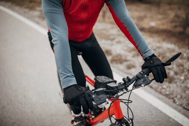istock Professional male cyclist riding bicycle on road 1302463848