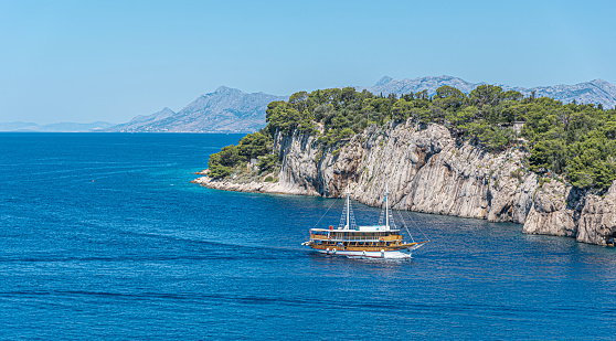Ship in rocky bay of the Adriatic Sea. The coast of Croatia.