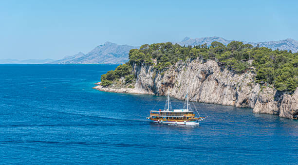 Ship in rocky bay of the Adriatic Sea. Ship in rocky bay of the Adriatic Sea. The coast of Croatia. dalmatian coast stock pictures, royalty-free photos & images