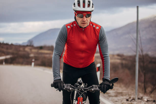istock Professional male cyclist riding bicycle on road 1302465465