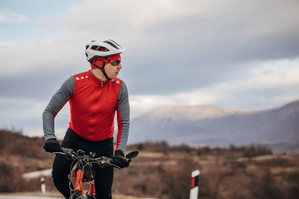 istock Professional male cyclist riding bicycle on road 1302465498