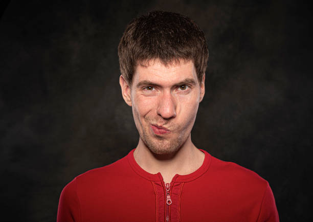istock Funny young guy portrait isolated on dark background 1302466563
