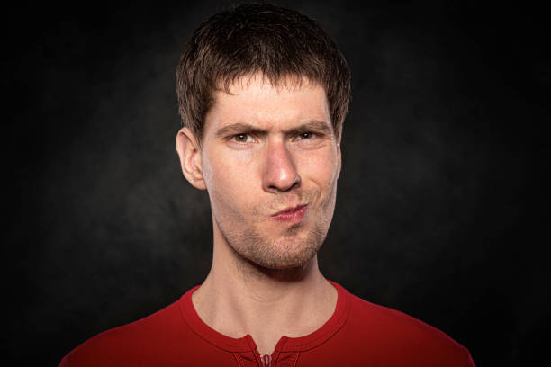 istock Funny young guy portrait isolated on dark background 1302466571