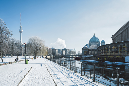 snowy Berlin cityscape with tv-tower and cathedral in the winter sun