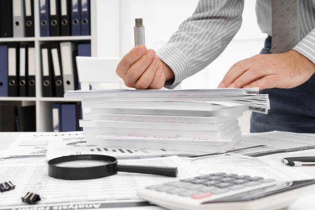 istock business concept - businessman's working table close view, shows the USB flash drive 1302469729