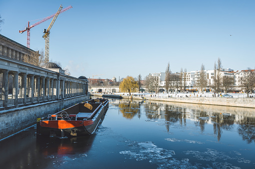 wide panoramic view from bridge in historic central berlin over spree river and cityscape on sunny  winter day