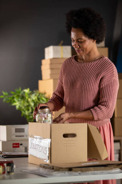 istock Adding little bit of sweetness in a donations box 1302474486
