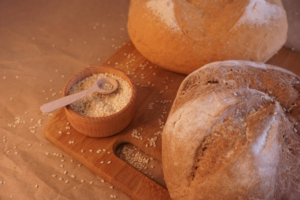 istock Round loaf bread with some slices cut 1302474889