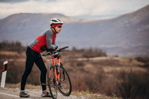 istock Professional cyclist looking at view by the road 1302476175