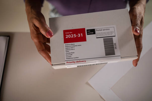istock Female hands holding a box with a label 1302476228
