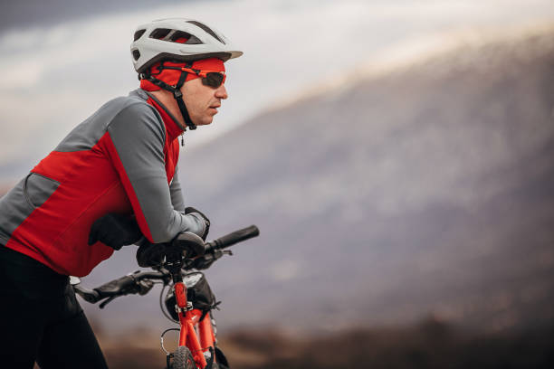 istock Professional cyclist looking at view by the road 1302476569