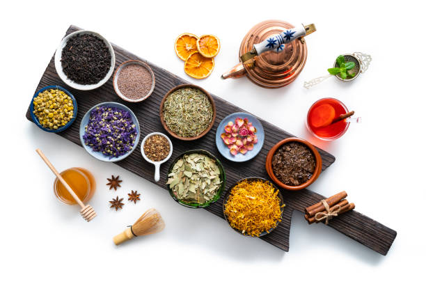 istock Tea and herbs dried assorted on wooden board isolated on white 1302477659