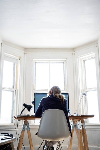 istock A woman working in her temporary home office 1302479215